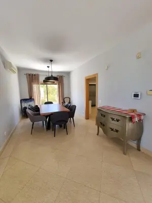 a living room with a table and chairs and a dining room at Luxury city Villa Olivia 10 - 15 min to the Beach Oura, private swimming pool in Albufeira