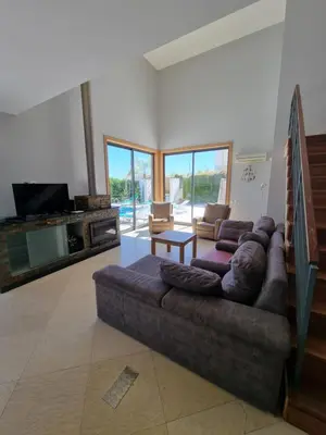 a living room with a large couch and a tv at Luxury city Villa Olivia 10 - 15 min to the Beach Oura, private swimming pool in Albufeira