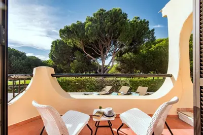 a white house with a large grass yard at Old Village Area and close to all amenities, Overlooking Golf Course in Quarteira