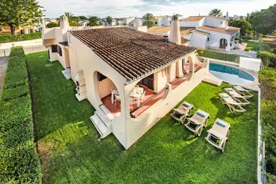 a white dining room with a table and chairs at Old Village Area and close to all amenities, Overlooking Golf Course in Quarteira