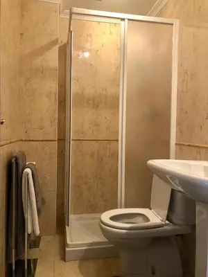 a bathroom with a shower and a toilet and a sink at Praia da Falésia - Falesia Beach - Apartment Pine Sun Park in Albufeira