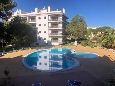 a swimming pool in front of a large building at Praia da Falésia - Falesia Beach - Apartment Pine Sun Park in Albufeira