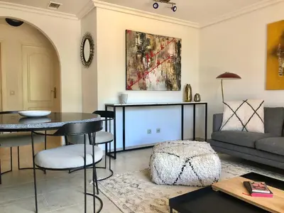 a living room with a table and a couch at Praia da Falésia - Falesia Beach - Apartment Pine Sun Park in Albufeira
