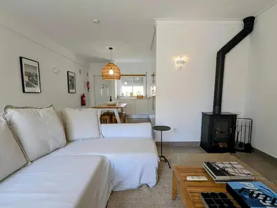 a balcony with a white railing and a table with a umbrella at 1A The Apartment in Albufeira