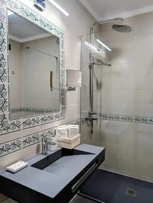 a bathroom with a sink and a mirror at 1A The Apartment in Albufeira