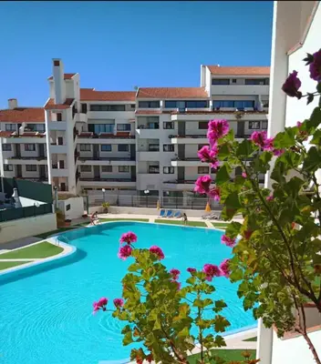 a large swimming pool in front of a building at Vila Magna Albufeira in Albufeira
