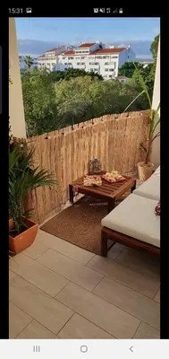 a patio with a table and a wooden fence at Vila Magna Albufeira in Albufeira