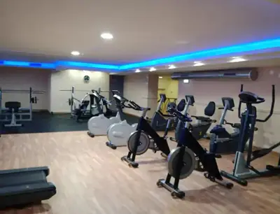a gym with several treadmills and elliptical machines at Vila Magna Albufeira in Albufeira