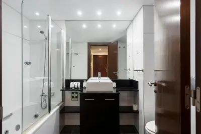 a white bathroom with a sink and a shower at Apartamento Monte Laguna in Vilamoura