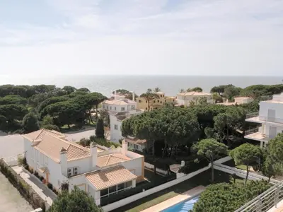 an aerial view of a house with the ocean in the background at Vila Falesia Penthouse in Albufeira