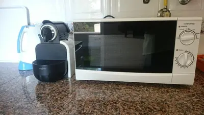 a microwave sitting on a counter next to a blender at Falesia - near the beach - The GAVEL Apartment in Albufeira