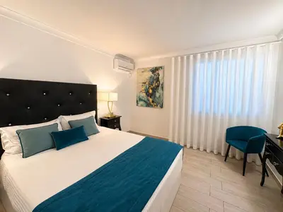 a bedroom with a bed and a desk and a chair at Villa Cristina 17 - 500 m from the Beach in Albufeira