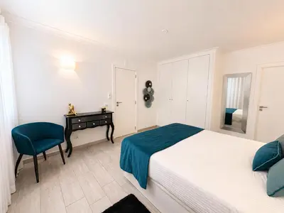 a bedroom with a bed and a desk in it at Villa Cristina 17 - 500 m from the Beach in Albufeira