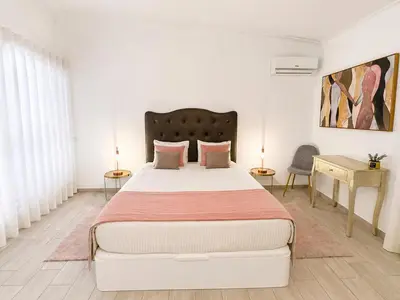 a white bedroom with a bed with pillows at Villa Cristina 17 - 500 m from the Beach in Albufeira