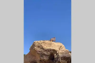 a cross sitting on top of a rock at Salgados Beach and Relax in Guia