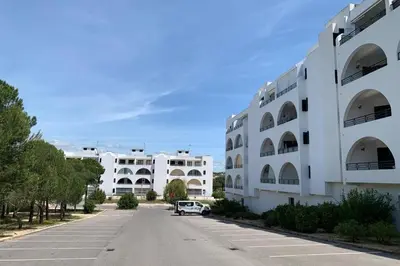 an empty street in front of a white building at Salgados Beach and Relax in Guia