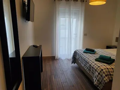 a bedroom with a bed and a dresser and a window at 