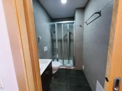 a bathroom with a toilet and a glass shower at 