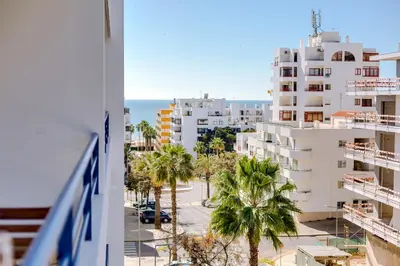 a view of a city with palm trees and buildings at Colina Sol T2 Quarteira Beach in Quarteira