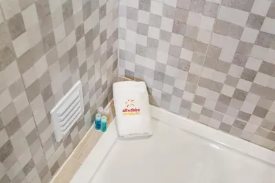 a towel sitting on top of a toilet in a bathroom at Elma By Albufeira Rental in Albufeira