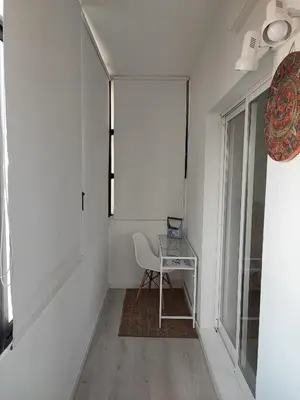 a small white room with a table and a chair at Milu house in Faro