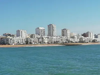 a view of a city with a beach and buildings at Mira Praia, Sunny and Sea in Quarteira