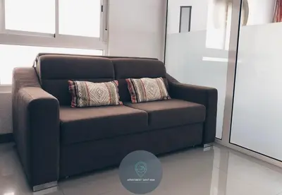 a brown couch with two pillows in a room at Apartment Sant'Ana Old Town Albufeira - Bay View in Albufeira