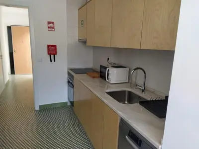 a small kitchen with a sink and a microwave at Urban Apartment in Faro