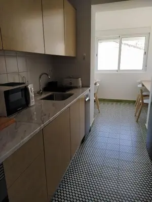 a kitchen with a sink and a microwave at Urban Apartment in Faro