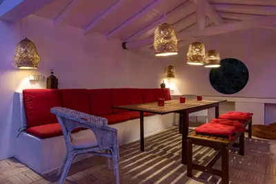 a living room with a red couch and a table at Villa AL Fresco in Guia