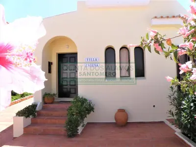 a white building with a blue door and stairs at Villa Catuna - Quinta do Jolu in Guia