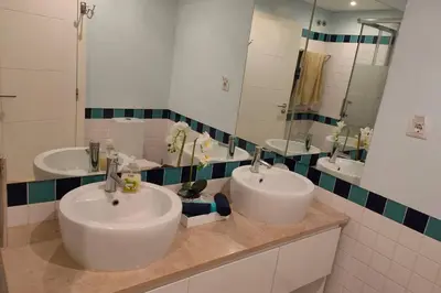 a bathroom with two sinks and two mirrors at Varandas Golden Beach in Quarteira