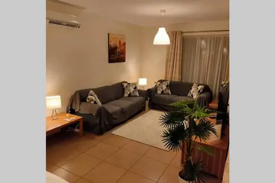 a living room with two couches and a table at Varandas Golden Beach in Quarteira