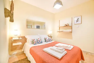 a bedroom with a bed with two towels on it at Elevator's Beach House by Atlantic Places in Albufeira
