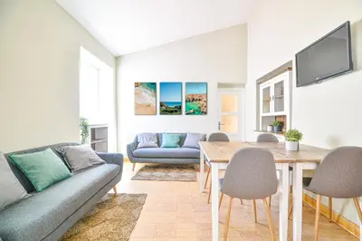 a living room with a couch and a table at Elevator's Beach House by Atlantic Places in Albufeira