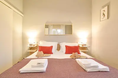a bedroom with a large bed with red pillows at Elevator's Beach House by Atlantic Places in Albufeira