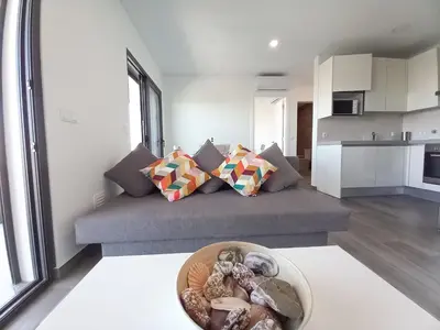 a living room with a couch and a bowl at Alto do Forte Novo- Ar- Condicionado, Wifi, Vista Mar in Quarteira