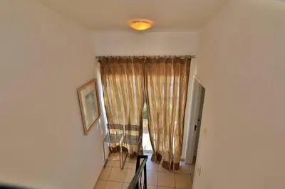 a room with a window with curtains on it at Casa Vale Do Lobo 32 Charming 2 Bedroom Townhouse Close To Beach in Vale do Lobo
