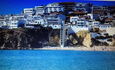 a view of a beach with white buildings at Apartament near the ocean in Albufeira