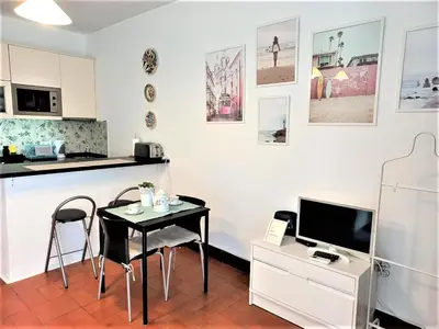 a kitchen with a table and a small table with chairs at Apartament near the ocean in Albufeira