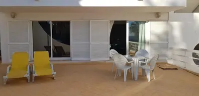 a dining room with a table and chairs on a patio at Praia Oura Sunset in Albufeira