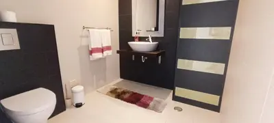 a bathroom with a toilet and a sink at Villas Rocha in Albufeira