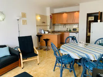 a kitchen and dining room with a table and chairs at Apartamento 806 in Albufeira