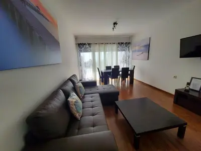 a living room with a brown leather couch and a table at 