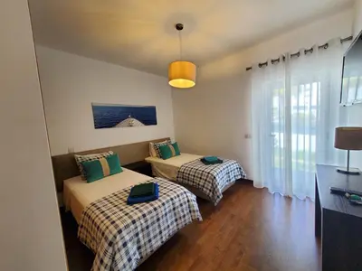 a bedroom with two beds and a window at 