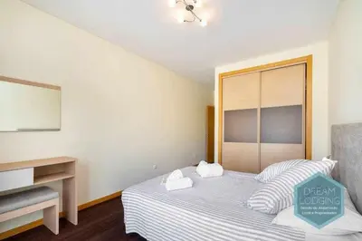 a bedroom with a bed with two towels on it at Medronheira B2 - Dream Lodging in Albufeira