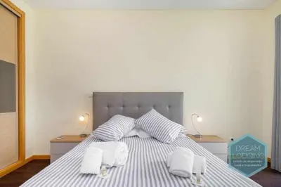 a bedroom with a bed with two towels on it at Medronheira B2 - Dream Lodging in Albufeira
