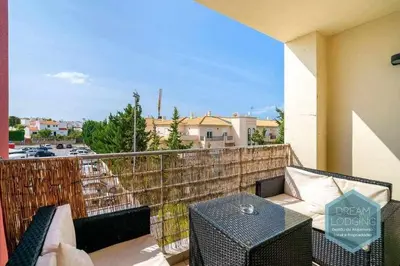 a balcony with a table and a view of a city at Medronheira B2 - Dream Lodging in Albufeira