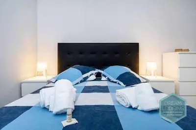 a blue and white bed with towels on it at Forte 303 - Dream Lodging in Albufeira