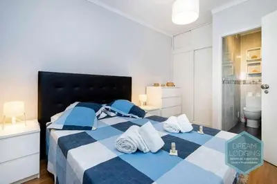 a blue and white bed with towels on it at Forte 303 - Dream Lodging in Albufeira